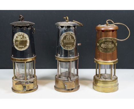 Three miners lamps to include British Coal Mining Company, Wales serial No. 55057 example and Eccles Protector Lamp &amp; Lig