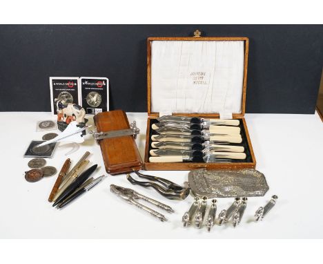 A small box of mixed collectables to include a wooden tie press, ladies purse,  small selection of commemorative crowns, nut 