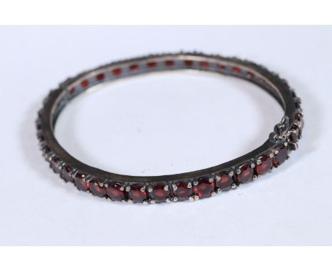 Substantial garnet set bangle 