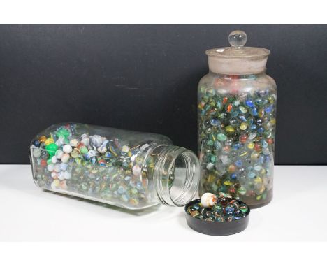 Two glass jars of mixed vintage marbles in varying sizes 