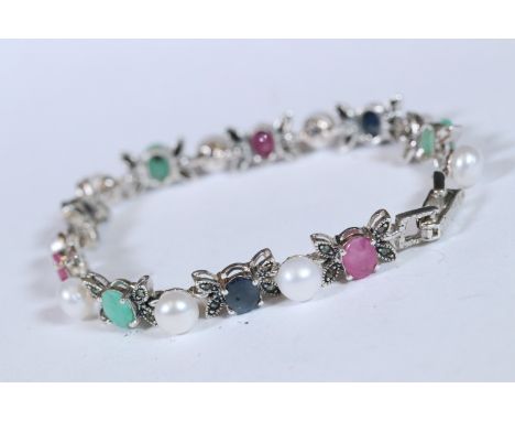 Multi silver stone set bracelet to include sapphire, ruby and emerald