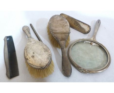 Two silver dressing table hairbrushes, hand mirror, clothes brush and comb. All A.F.