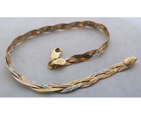 A Tri-colour plaited bracelet. In gold marked 750. 4.1g