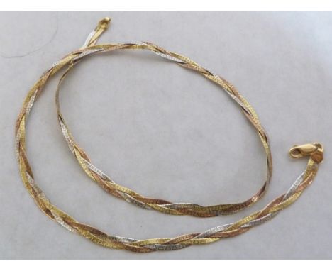 A tri-colour plaited necklace. In gold marked 750. 11.1g