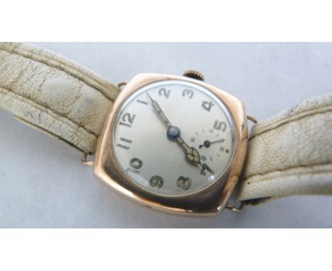 A 9ct cushion cased gentleman's wristwatch, the silvered dial with Arabic numerals. 32mm wide over crown. Movement runs