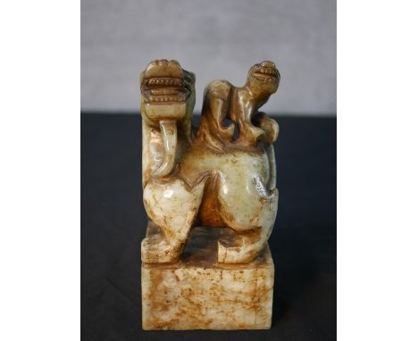 A carved Chinese green hardstone desk seal with a dragon with a salamander on his back with four character to base. H.16.5 W.