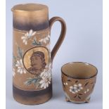 A Doulton Lambeth siliconware jug with slip and gilt decoration of flowers and a portrait of a