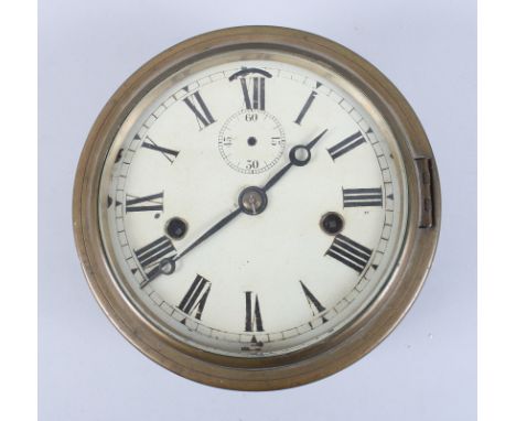A metal cased wall clock with brass cover, white enamel dial and Roman numerals