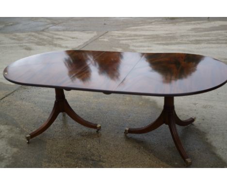 A Brights of Nettlebed figured mahogany dining table of Georgian design with extra leaf, on tripod splay supports, and a set 