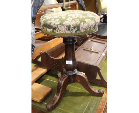 A polished as mahogany piano stool with adjustable circular seat, on tripod splay support