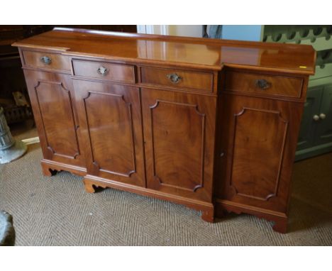 A Brights of Nettlebed figured mahogany breakfront sideboard, fitted four drawers over cupboards, on bracket feet, 72" wideCo