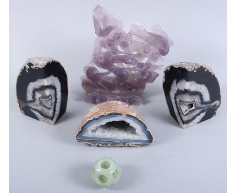A carved amethyst plaque of birds and flora, a carved jade ball and three crystal geodes