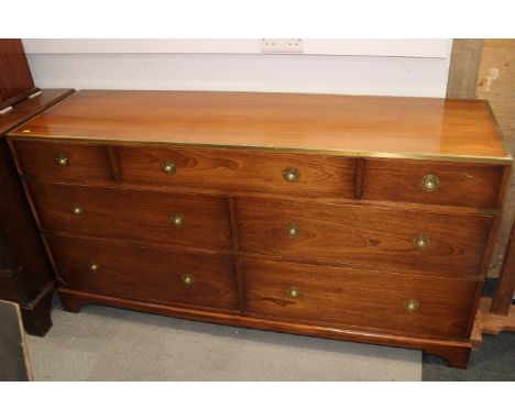 A 20th century campaign style mahogany and brass chest of seven drawers, on bracket supports, 60" wide x 30 1/2" high
