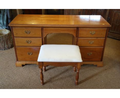 A cherrywood dressing table, fitted seven drawers, 52" wide, with three-fold mirror over, a dressing stool, on turned support