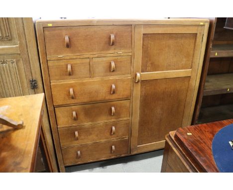 A Heal's style light oak chest/wardrobe, fitted two fall front drawers, four long drawers and cupboard, 53" wide x 54" high