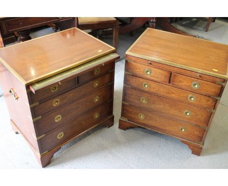 A pair of 20th century mahogany and brass campaign style bedside chests of two short and three graduated drawers with brush s