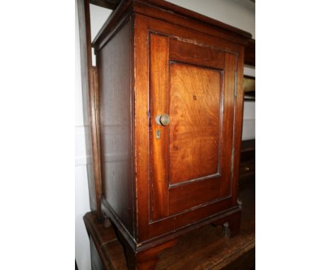 A mahogany bedside cabinet enclosed one door, on bracket feet, 16" wide
