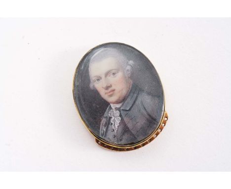 AN EARLY 19TH CENTURY MINIATURE PORTRAIT OF A GENTLEMAN mounted in a gold clasp from a stock or cravatte (behind glass);  1.5