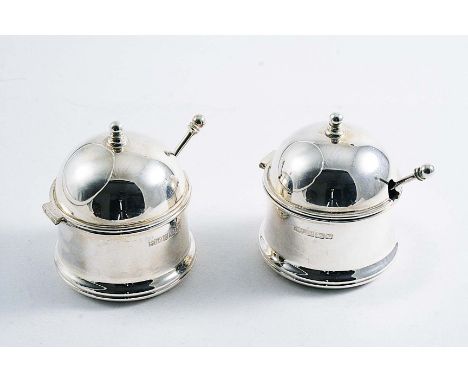 A PAIR OF CONTEMPORARY MUSTARD POTS with domed covers, ball finials, blue glass liners & matching spoons, by Martyn J. Pugh, 