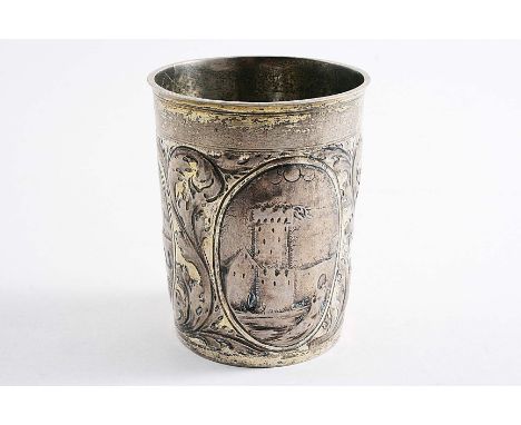 A LATE 17TH / EARLY 18TH CENTURY GERMAN PARCELGILT BEAKER of plain tapering form chased with three oval architectural vignett