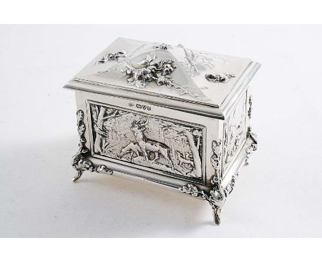 A SMALL EDWARDIAN JEWEL CASKET with embossed panelled sides depicting deer, ducks, pheasant & a boar, the cover with a frog, 