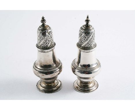 A PAIR OF EARLY GEORGE III BALUSTER PEPPER CASTERS (with slight finial differences), each scratched with the initials "H" ove