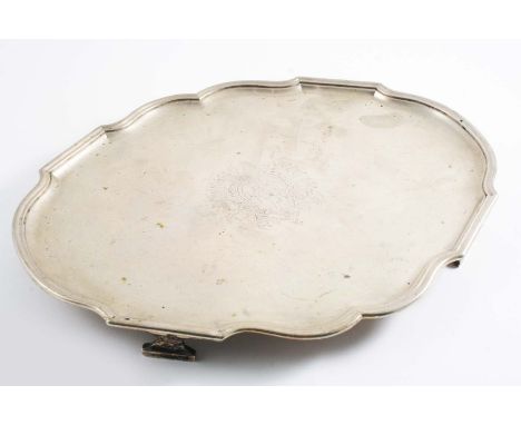A MID 18TH CENTURY UNASCRIBED SALVER of shaped oval outline with a moulded border & bracket feet, the centre engraved with a 
