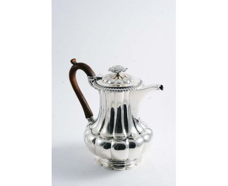 BY PAUL STORR:- A George IV hot water jug of baluster form with melon-fluting, a polyfoil foot and a gadrooned border around 