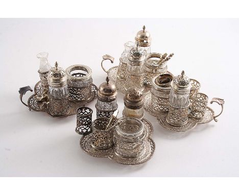 FOUR LATE VICTORIAN BREAKFAST CRUET SETS on pierced quatrefoil bases, all A/F, all by George Fox, London 1880/1892; the bases