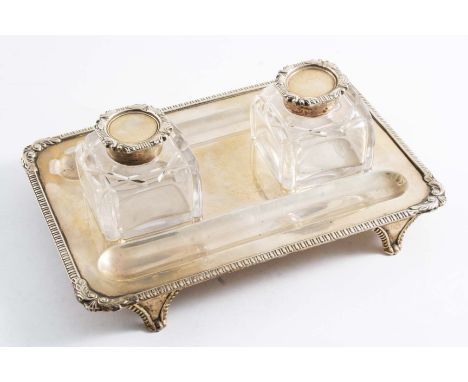 A LATE VICTORIAN INKSTAND with two mounted, cut-glass bottles, bracket feet, gadrooned borders and leafy shell corners, by Ch