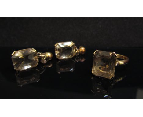 A gold ring set with a smoky quartz in four claw mount, stamped 18ct. Size N 5.3g and a pair of matching drop earrings, 7.3g