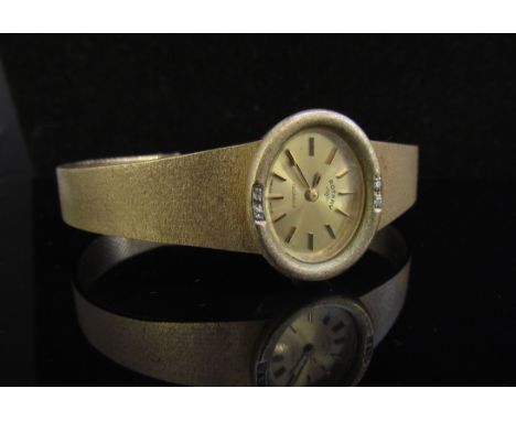 A 9ct gold lady's Rotary wristwatch with four diamonds set to bezel, 31g
