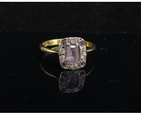 A gold ring centrally set with emerald cut amethyst (large chip) framed by diamonds and amethysts, unmarked. Size P, 3.5g