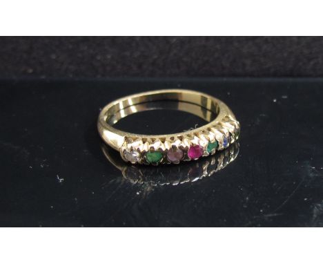 A 9ct gold multi stone ring set with seven stones including emerald spelling ''Dearest''. Size O, 2g