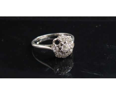 A platinum diamond daisy ring, one stone missing. Size J/K, 2.5g