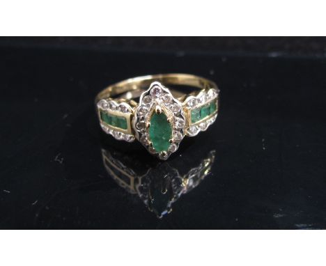 A 9ct gold emerald and diamond chip dress ring. Size O, 2.1g