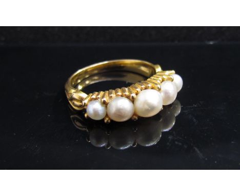 A gold ring set with five graduated pearls, unmarked. Size N, 4.6g