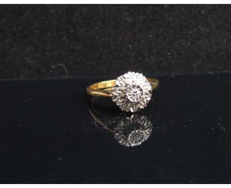 An 18ct gold illusion set diamond cluster ring. Size N, 3.7g