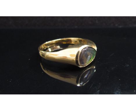 A gold ring stamped 18k set with pear shaped opal, size O, 4.4g