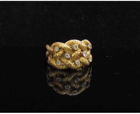 An 18ct gold ring with woven detail set with eight diamonds. Size P, 8.5g