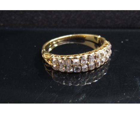 A gold diamond set half hoop ring with double row of diamonds, unmarked. Size O, 3g