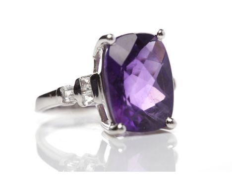 AMETHYST AND WHITE GEM SET RINGwith a central cushion shaped amethyst measuring 14 x 10mm, on white gem set shoulders, marked
