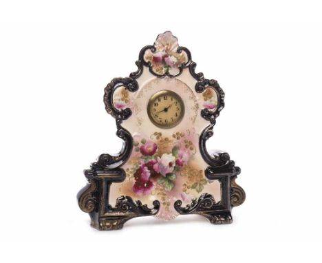 ORNATE CERAMIC MANTEL CLOCKlater quartz movement, the later dial with Arabic numerals, Pierced steel hands, the scrolling cas