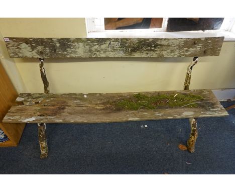 A Victorian cast iron garden bench,&nbsp;on branch form supports. 