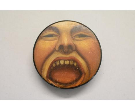 An unusual 19th century Stobwasser style papier mache circular snuff box and cover, decorated with an open mouth, 5.8cm diame