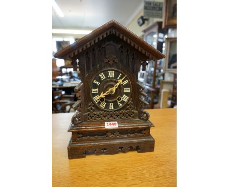 A Black Forest carved oak cuckoo mantel clock,&nbsp;31cm high, (no pendulum). 