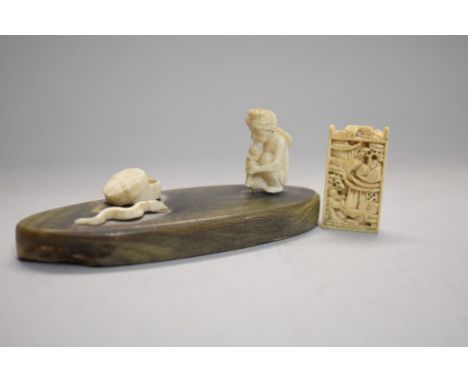 An Indian ivory and horn snake charmer figure group,&nbsp;10cm wide; together with a Chinese ivory abacus pendant, 3.5cm long