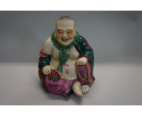 A Chinese famille rose Buddha,&nbsp;28cm high; together with a green jade necklace.&nbsp; 