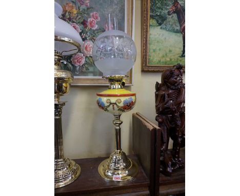 A brass oil lamp, with opaque glass reservoir, height including shade 60cm.&nbsp; 