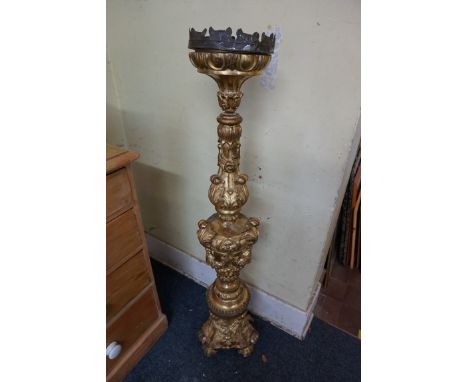 A large 17th century style carved giltwood candlestick,&nbsp;125cm high. 